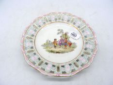A Meissen pierced plate, mid-19th century, painted with travellers in a landscape,