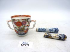 An early Meissen chocolate cup and two knife handles, circa 1725-40,