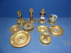 A quantity of brass Trench Art mostly ashtrays, a candlestick and matchbox holder.