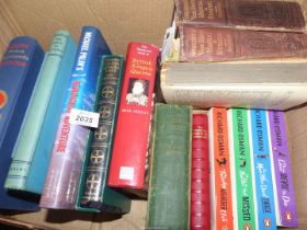 A box of books to include Richard Osman novels, Michael Plain's Hemmingway Adventures, a Bible etc.