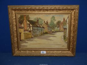 A gilt framed Oil on board titled verso 'Old Cottage Elmley Castle', signed lower right 'C.A.
