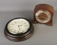 Two clocks to include an oak cased Garrard mantle clock and a wall clock from the Towcester Clock