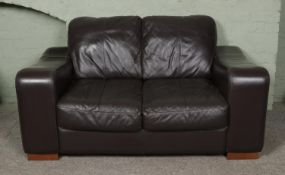 A brown leather two seater sofa. Approx. width 151cm.