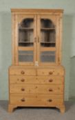 A 19th century stripped pine glazed dresser/bookcase. Hx209cm Wx102cm Dx59cm Appears to be a