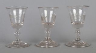 Three Georgian bucket bowl gin glasses, having engraved fern blade to the bowl, knop stem and folded