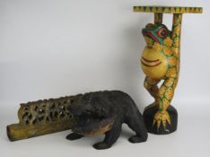 A polychrome decorated wood stand in the form of a frog, 48cm high, a carved wood figure of a bear