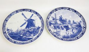Two mid 20th century Dutch delft wall chargers, with traditional decoration of windmill pastoral