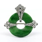 A good Art Deco circular jade and diamond set pendant/brooch, possibly set in platinum/18ct white