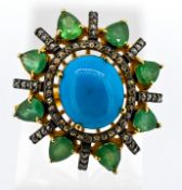 Large and impressive dress ring set with an oval cabochon turquoise, pear shaped emeralds and