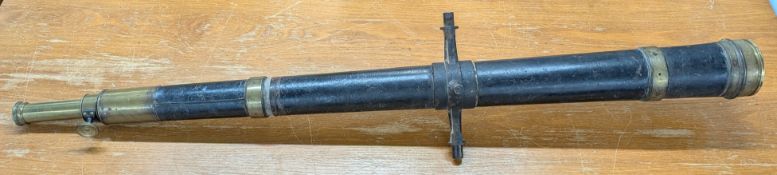 A large antique ships single draw telescope, of black leather with brass fittings, with mount to