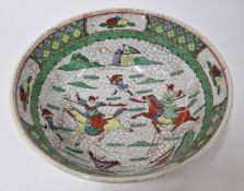 A Chinese bowl, decorated with soldiers on horseback in green, with painted cracking decoration