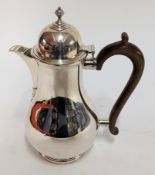 A silver coffee pot with wooden handle, hallmarked London 1926, weight approx. 21.45oz.