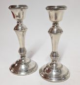 A pair of silver candlesticks, hallmarked Birmingham 1976/1989, total weight approx. 31.6oz.