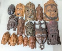 A collection of carved wooden masks and faces.