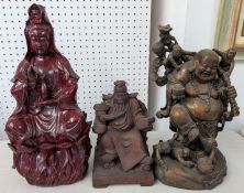 Three large wooden figures, to include a Buddha.