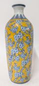 A Chinese porcelain vase, decorated with blue flowers with yellow glaze, height approx 34cm.