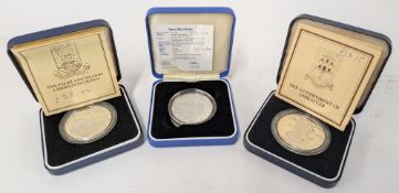 Three commemorative silver coins with certificates of authenticity in presentation cases to