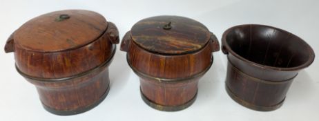 Three Chinese brass bound rice buckets, two with lids, brass banding and carved handles. (3)