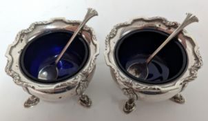 A pair of silver salts with blue glass inserts and silver teaspoons, hallmarked Birmingham 1946,