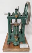 A scale model of the 1841 Bodmer Sliding Cylinder Engine, dark green painted, height approx 41cm, on