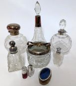 A collection of silver mounted perfume bottles, various sizes, and electroplated sugar bowl,