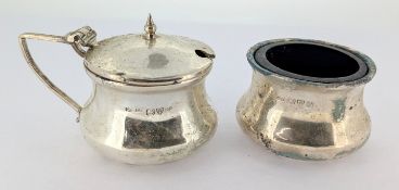 A silver mustard pot and salt with blue glass inserts, silver weight approx 1.11oz.