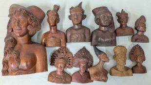 A collection of carved wooden Klungkung busts.