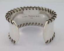 Tiffany & Co, a silver Whipstitch cuff bangle, marked inside Tiffany & Co, 2001, 925, approx 86g,