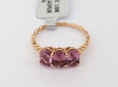 Gemporia, a pink sapphire three stone set ring, set in 9ct rose gold, size N/O, with certificate
