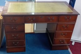 A dark wood pedestal desk with green leather surface, height 79, width 121cm.