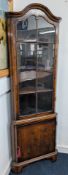 An Edwardian art nouveau style mahogany corner cabinet, with glazed upper cabinet door, height