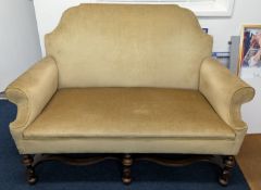 A 1920s reproduction Jacobean style settee, of cream velvet upholstery on carved legs, width