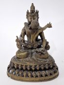 A Tibetan bronze Buddhist figure and consort embracing, height approx 19cm.