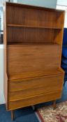 A mid-century style 1970s wood bureau, with three drawers, below a fold down desk, height approx