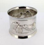 A white metal napkin ring with embossed chicks, weight approx 1.48oz.