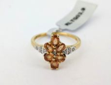Gemporia, a Songea orange sapphire and white zircon set ring, set in 9ct yellow gold, size S, with