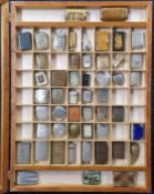 A large collection of vesta cases, to include some silver examples, in a fitted cabinet, approx 56cm