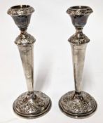 A pair of George V silver candlesticks, embossed foliate decoration, hallmarked Birmingham 1910/