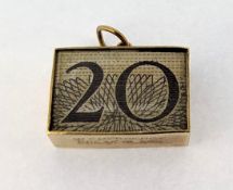 A 9ct yellow gold charm/pendant encased with an old British £20 note, total weight 3.2g.
