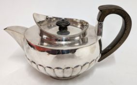 A George III silver teapot with wooden handle, hallmarked London 1804, weight approx. 22.8oz.