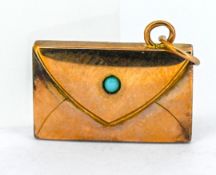 An Edwardian envelope pendant with a small turquoise inset, set in rose gold, approx 1.8g.