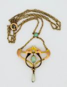 A Liberty & Co Art Nouveau style opal pendant and chain, set in gold.