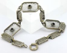 An Art Deco style frosted crystal and diamond set bracelet, set in white gold filigree, length