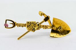 A South Africa Miners gold brooch, decorated with miniature mining tools, set in 9ct yellow gold,