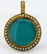 A gold and pearl set pendant/locket, set in gold (not hallmarked), with a hinged back.