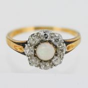 An opal and diamond cluster ring, mounted in yellow gold. Size N. Total weight approximately 3.3?g.