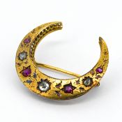 A Victorian crescent brooch, set with rubies and diamonds, mounted in yellow gold (not