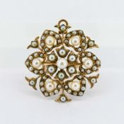 A Victorian-style brooch/pendant, set with pearls in a floral or snowflake design, mounted in 9ct