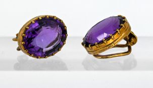 A pair of oval-cut amethyst clip-on earrings, mounted in 9ct yellow gold.