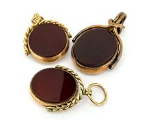 Three antique 9ct gold swivel fobs, set with bloodstone and carnelian. Total weight approximately